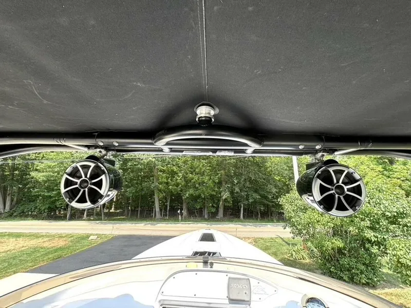 Slide: The Image of 2005 Donzi 33ZX boat speakers and canopy, with a view of surrounding greenery. - 42