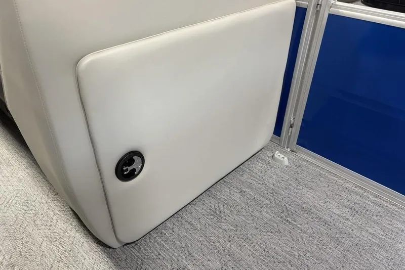 Slide: The Image of 2026 Sun Tracker Fishin' Barge 20 DLX interior detail with white upholstery and blue panel. - 11