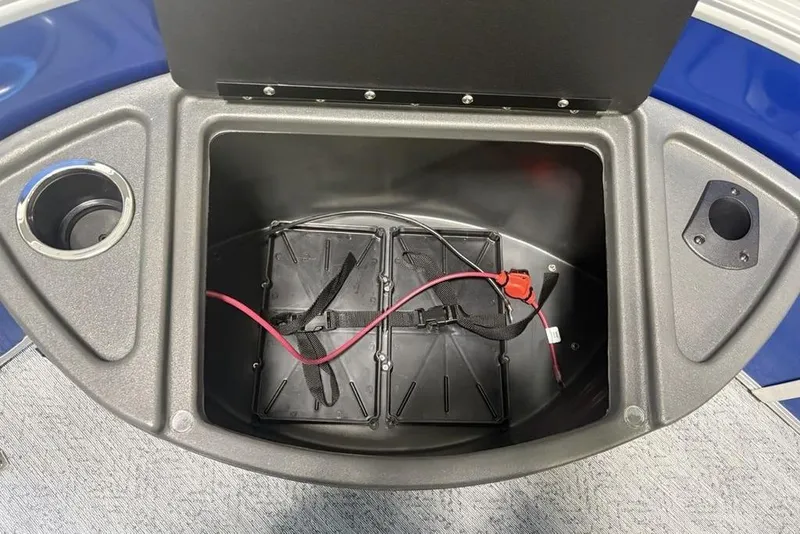Slide: The Image of Storage compartment of 2026 Sun Tracker Fishin' Barge 20 DLX with wiring and cup holder. - 12