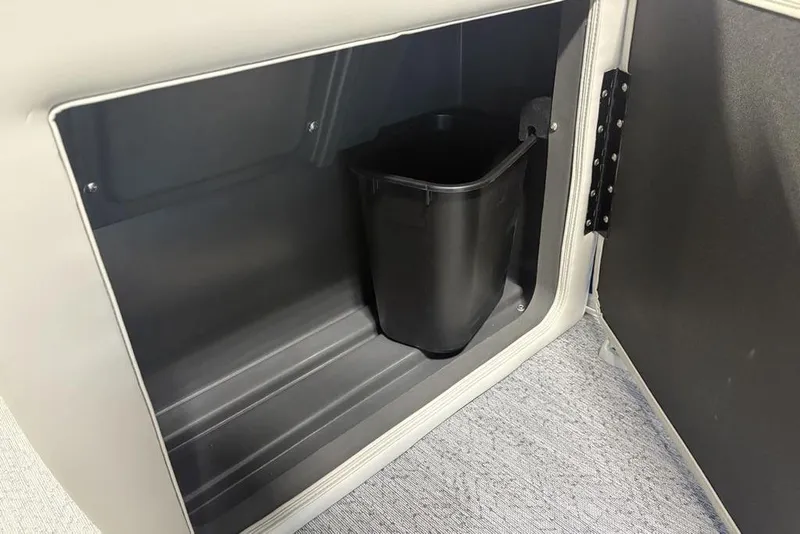 Slide: The Image of Storage compartment with trash bin in 2026 Sun Tracker Fishin' Barge 20 DLX boat. - 15