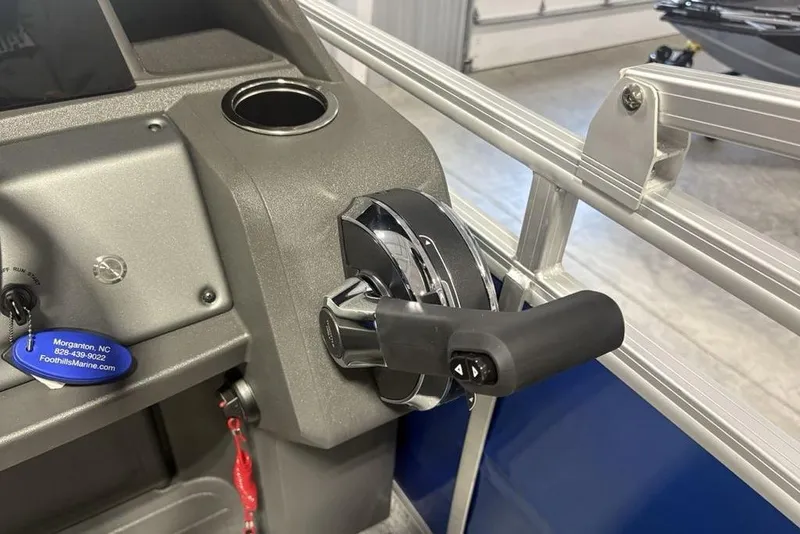 Slide: The Image of Control panel of 2026 Sun Tracker Fishin' Barge 20 DLX with throttle lever and cup holder. - 19