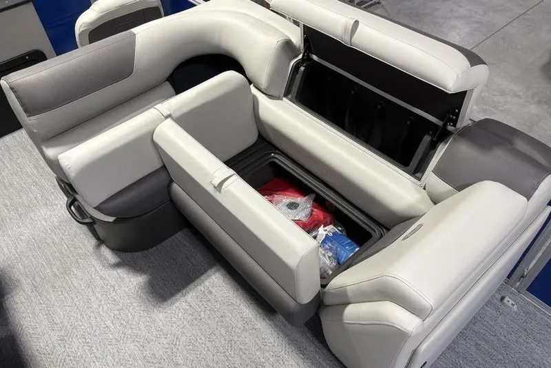 Slide: The Image of 2026 Sun Tracker Fishin' Barge 20 DLX seating with storage compartments open, showcasing interior space. - 20