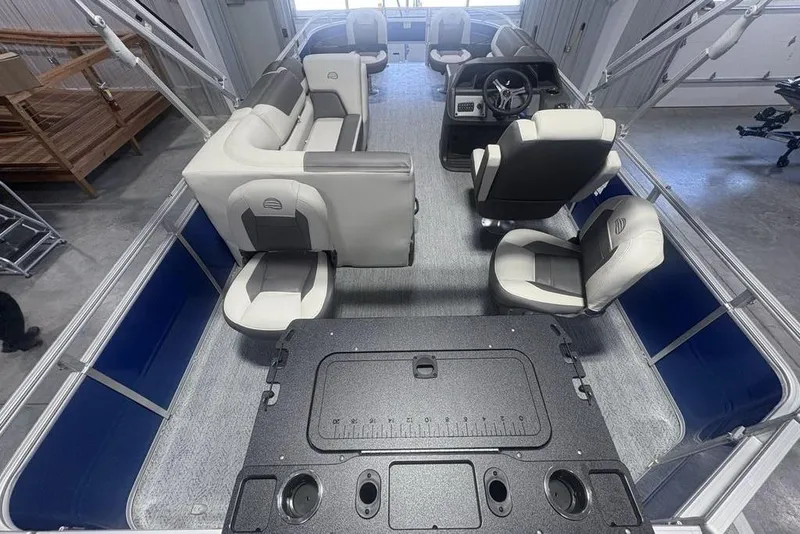 Slide: The Image of 2026 Sun Tracker Fishin' Barge 20 DLX interior with seating and steering console. - 28