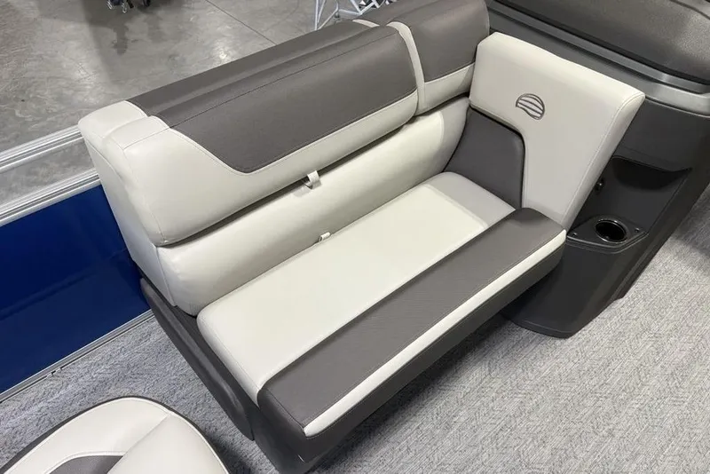 Slide: The Image of 2026 Sun Tracker Fishin' Barge 20 DLX boat seating, featuring gray and white upholstery. - 7