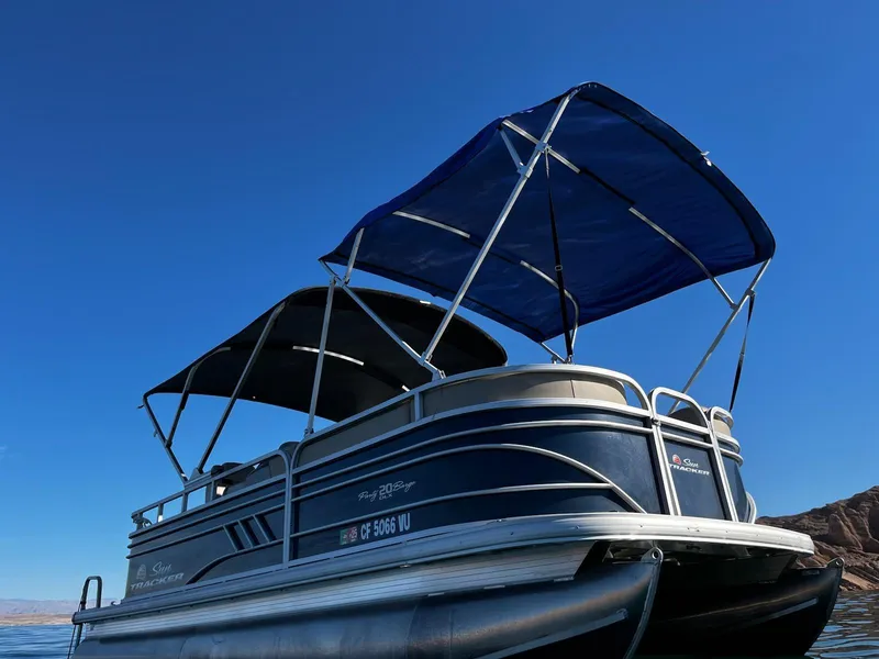 Slide: The Image of 2022 Sun Tracker Party Barge 20 DLX pontoon boat with blue canopy on a sunny day. - 6