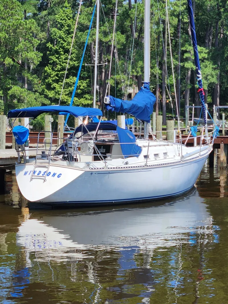 The Image of 1982 C&C 34 sailboat docked in a serene marina setting. - 0