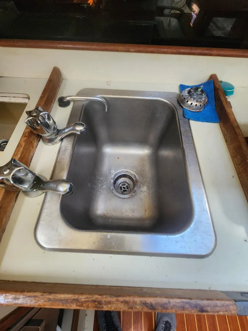 Slide: The Image of Stainless steel sink in 1982 C&C 34 yacht galley with wooden trim. - 14