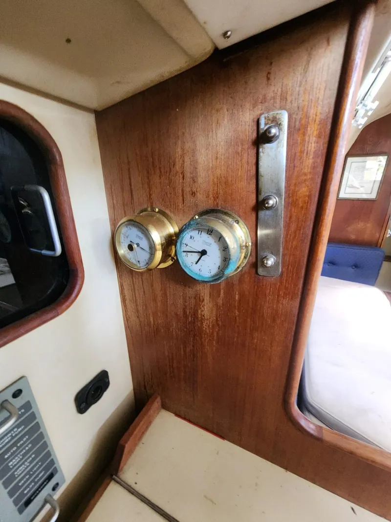 Slide: The Image of Interior of 1982 C&C 34 sailboat with brass gauges on wooden panel. - 15