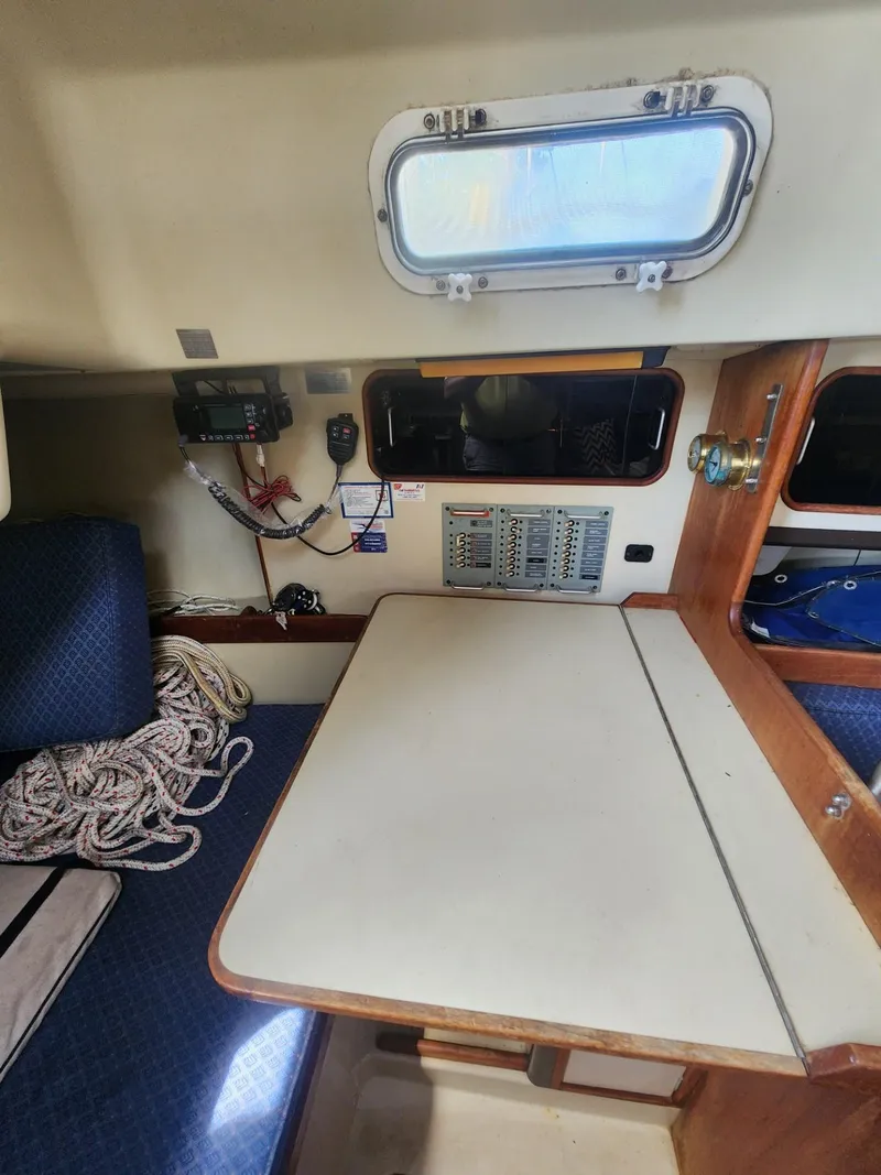 Slide: The Image of Interior of a 1982 C&C 34 sailboat with navigation equipment and seating area. - 16