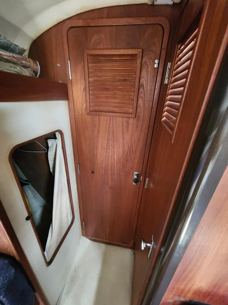 Slide: The Image of Interior of 1982 C&C 34 sailboat with wooden door and closet space. - 24
