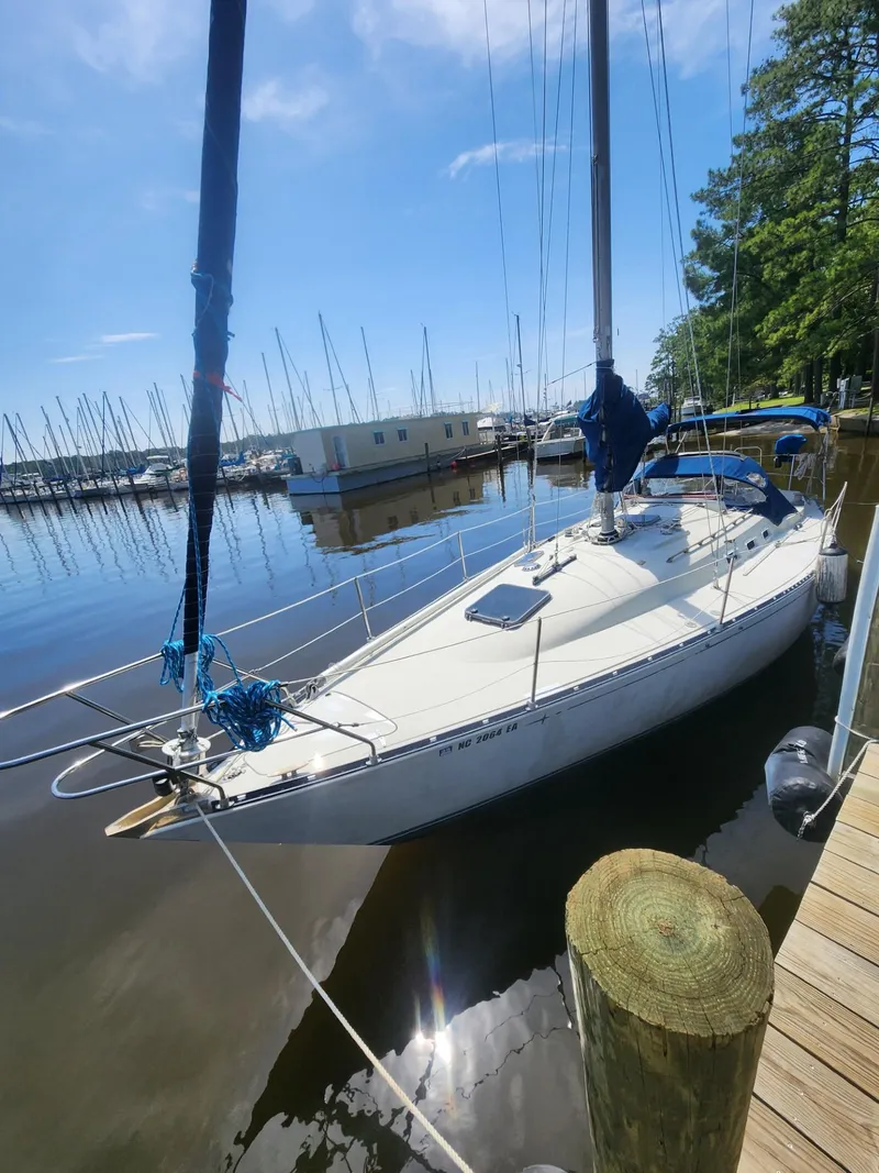 Slide: The Image of 1982 C&C 34 sailboat docked at a marina on a sunny day. - 3