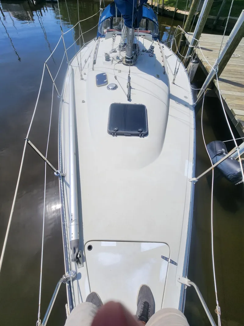Slide: The Image of Sailboat deck view of 1982 C&C 34, docked in calm waters. - 8