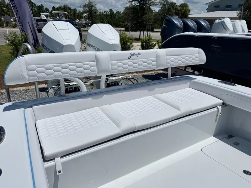 Slide: The Image of 2026 Yellowfin 26 Hybrid boat with Garmin equipment, docked outdoors under blue sky. - 10