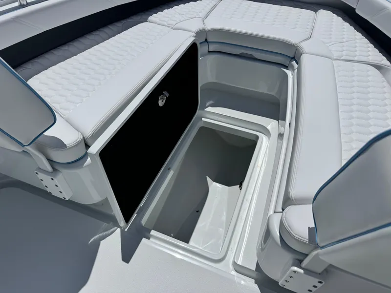 Slide: The Image of 2026 Yellowfin 26 Hybrid boat seat with hexagonal pattern and blue trim. - 14