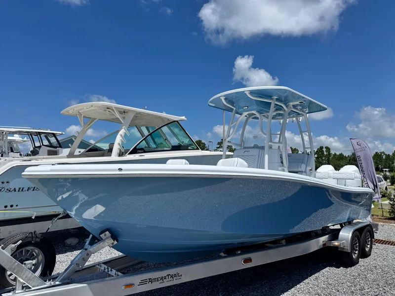 Slide: The Image of 2026 Yellowfin 26 Hybrid boat interior with cushioned seating and Mercury engines. - 16