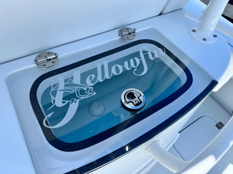 Slide: The Image of 2026 Yellowfin 26 Hybrid boat console with storage compartment and cup holder. - 17