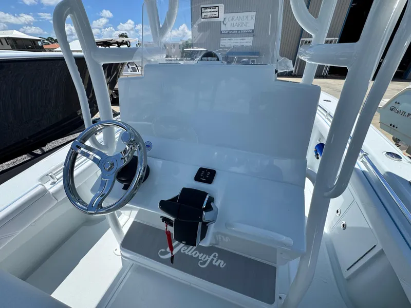 Slide: The Image of 2026 Yellowfin 26 Hybrid boat storage compartment with blue hose and speaker. - 23
