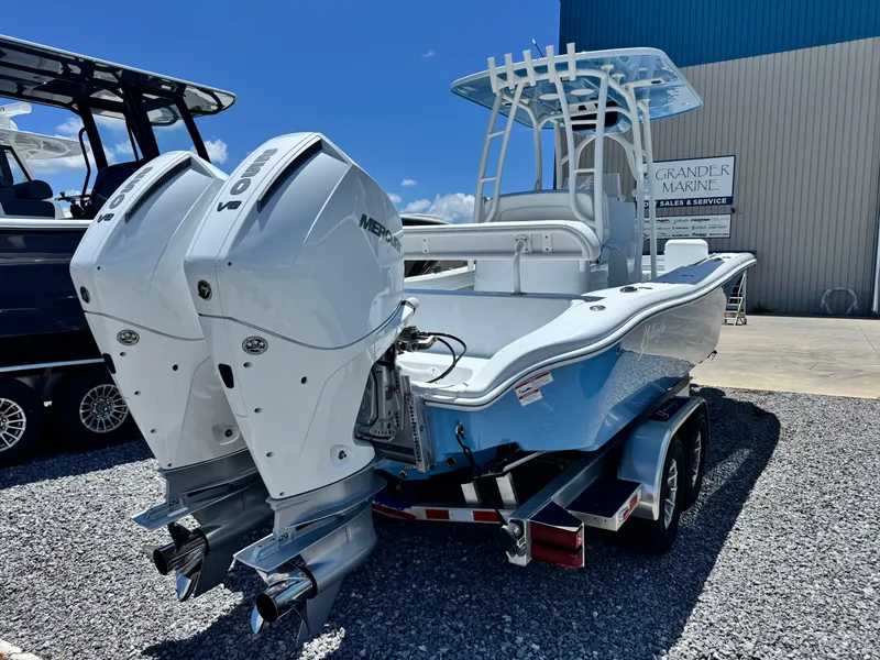 Slide: The Image of 2026 Yellowfin 26 Hybrid boat with dual outboard engines, displayed at a marina. - 4