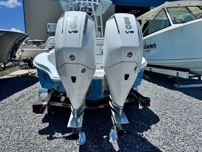 Slide: The Image of 2026 Yellowfin 26 Hybrid boat with Mercury engine on trailer, under clear blue sky. - 5