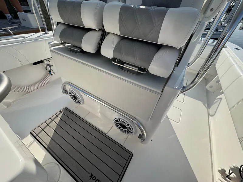 Slide: The Image of 2022 Contender 32 ST boat interior with cushioned seating and marine speakers. - 11