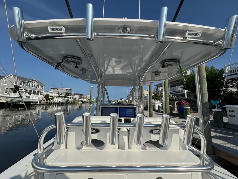 Slide: The Image of 2022 Contender 32 ST boat with rod holders, docked in a residential marina. - 14