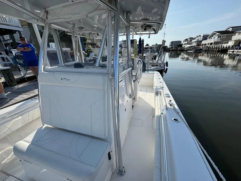Slide: The Image of 2022 Contender 32 ST boat docked, showcasing sleek white interior and modern design. - 17