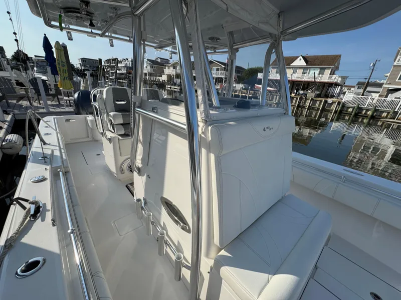 Slide: The Image of 2022 Contender 32 ST boat interior with sleek seating and modern design at a marina. - 18