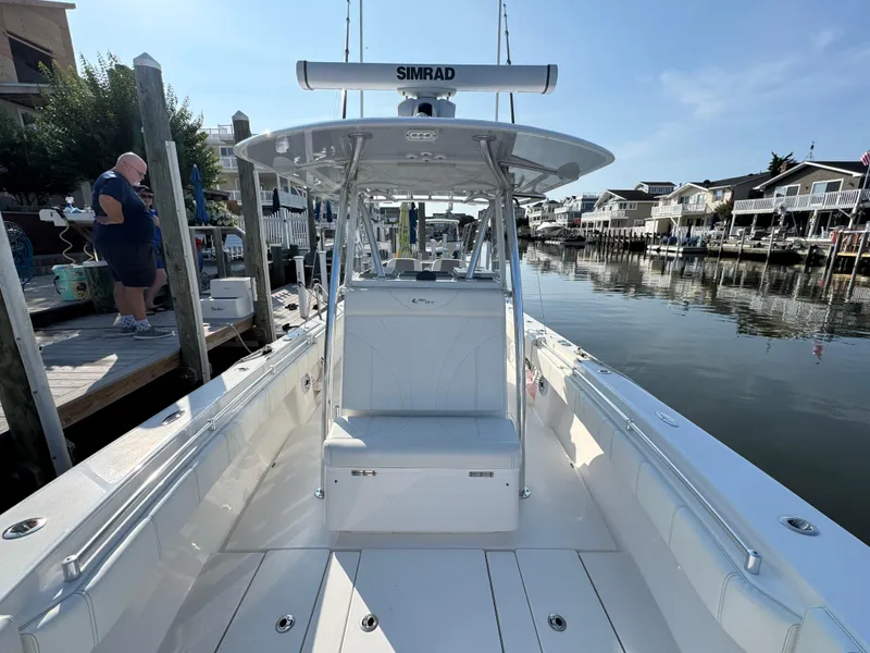 Slide: The Image of 2022 Contender 32 ST boat docked, featuring sleek design and spacious deck. - 19