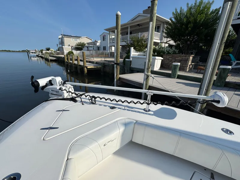 Slide: The Image of 2022 Contender 32 ST boat docked, featuring a Minn Kota trolling motor. - 20