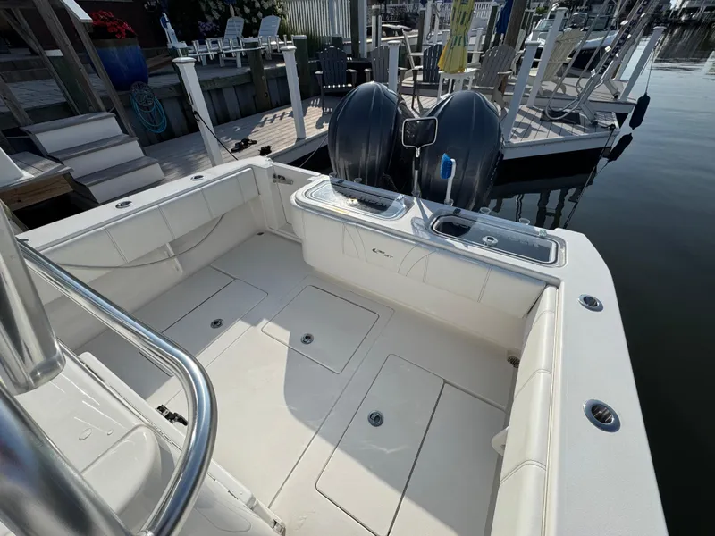Slide: The Image of 2022 Contender 32 ST boat interior with dual engines, docked at marina. - 21