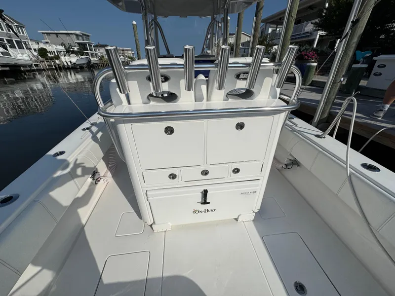 Slide: The Image of 2022 Contender 32 ST boat interior with rod holders and storage compartments. - 22