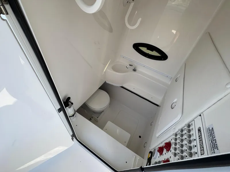 Slide: The Image of 2022 Contender 32 ST boat interior with toilet and control panel. - 23