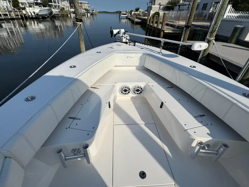 Slide: The Image of 2022 Contender 32 ST boat interior, featuring spacious seating and modern design in a marina setting. - 24