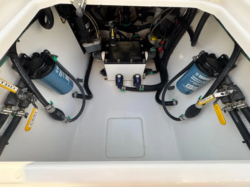 Slide: The Image of 2022 Contender 32 ST boat engine compartment with Yamaha filters and hoses. - 25