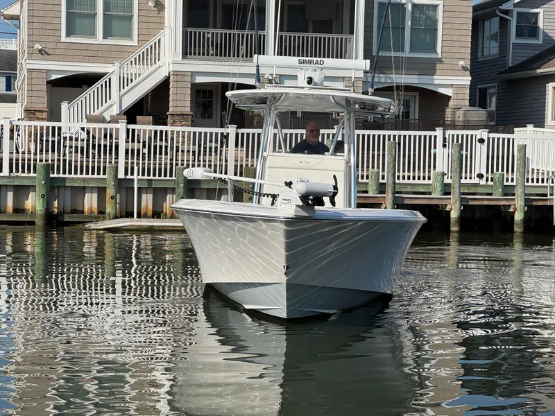 Slide: The Image of 2022 Contender 32 ST boat docked near waterfront homes. - 3