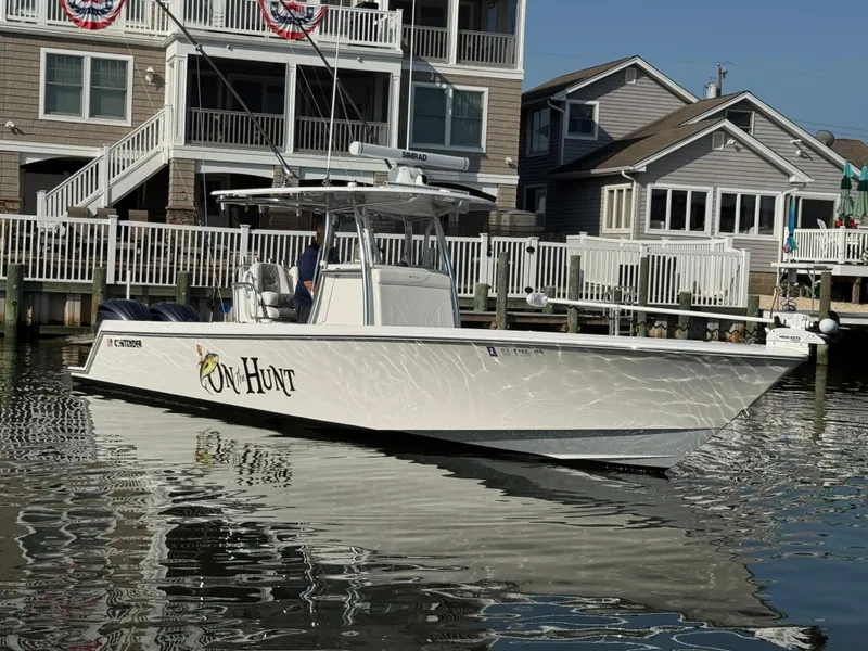 Slide: The Image of 2022 Contender 32 ST boat docked near waterfront homes. - 4