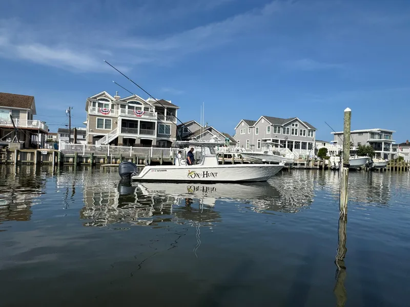 Slide: The Image of 2022 Contender 32 ST boat on calm water near waterfront homes. - 7