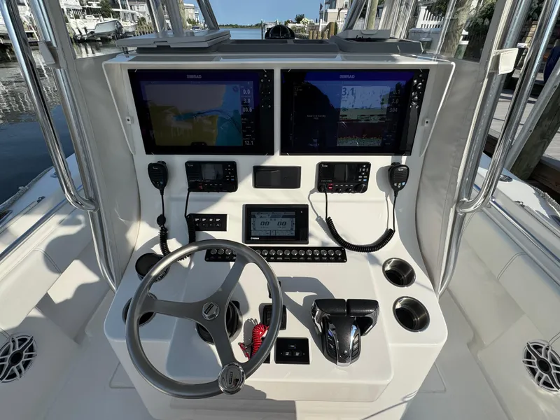 Slide: The Image of 2022 Contender 32 ST boat console with dual Simrad displays and steering wheel. - 9