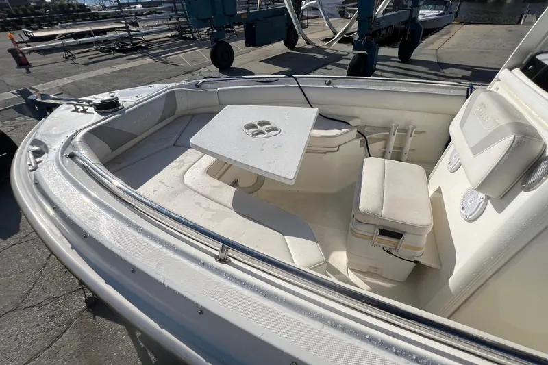Slide: The Image of 2015 Boston Whaler 220 Outrage boat interior with seating and table setup. - 10