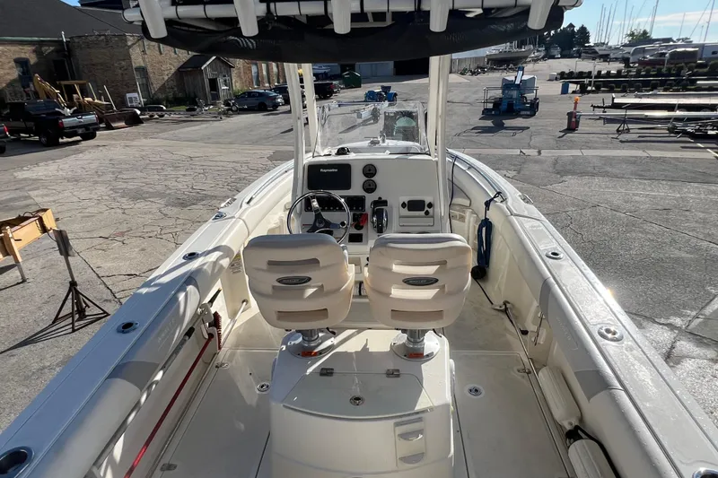 Slide: The Image of 2015 Boston Whaler 220 Outrage boat interior with dual seats and steering console. - 15