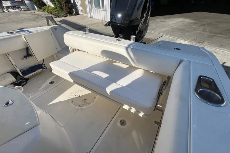Slide: The Image of 2015 Boston Whaler 220 Outrage boat interior with seating and engine view. - 18