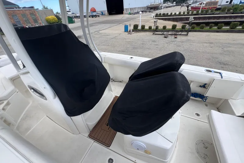 Slide: The Image of 2015 Boston Whaler 220 Outrage boat interior with covered seats and deck view. - 22