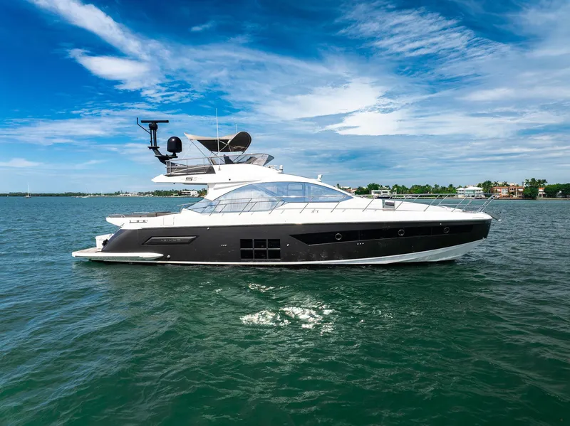 The Image of 2021 Azimut S6 yacht cruising on open water under a clear blue sky. - 0