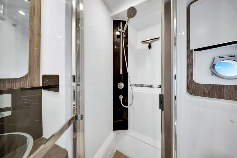 Slide: The Image of Luxurious bathroom in 2021 Azimut S6 yacht with modern shower and porthole window. - 36