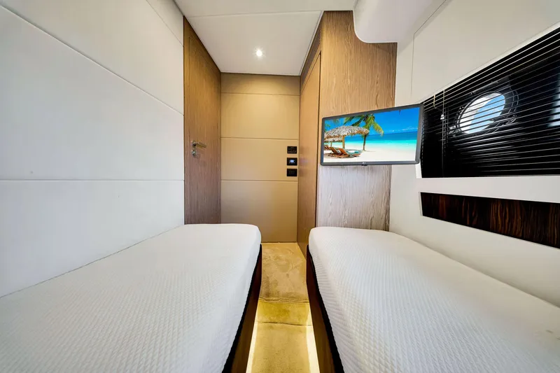 Slide: The Image of Luxurious 2021 Azimut S6 yacht cabin with twin beds and a scenic TV display. - 42