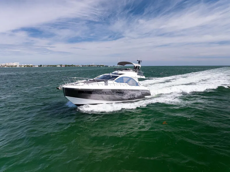 Slide: The Image of 2021 Azimut S6 yacht cruising on open water under a clear sky. - 44