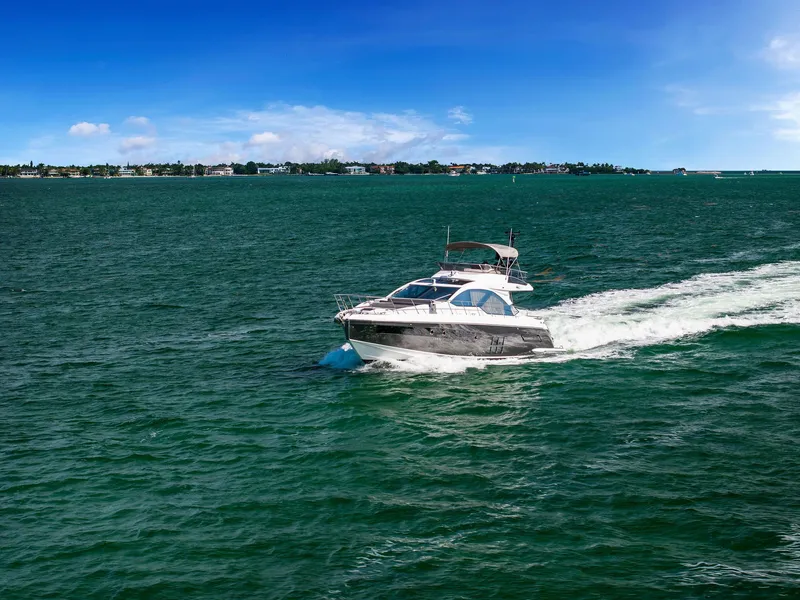 Slide: The Image of Azimut S6 2021 yacht cruising on open water under a clear blue sky. - 49