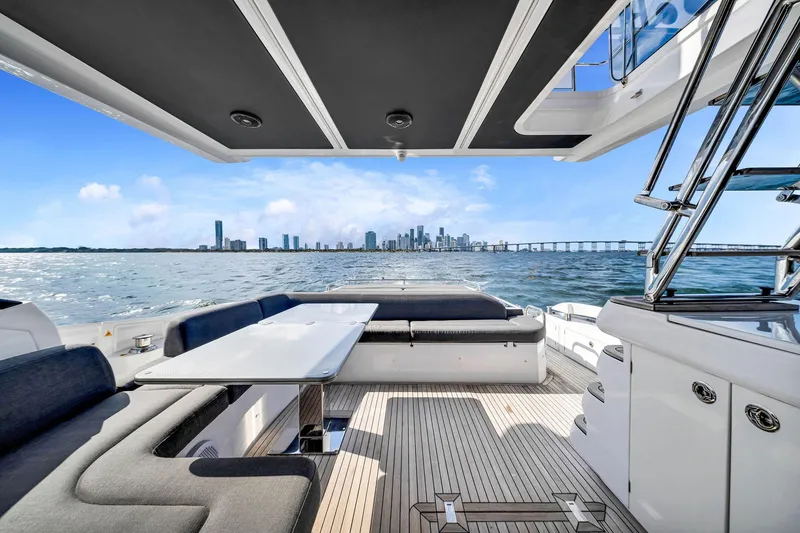 Slide: The Image of Luxurious 2021 Azimut S6 yacht interior with ocean view and city skyline in the background. - 5