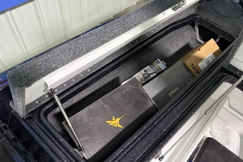 Slide: The Image of Open storage compartment in 2026 Phoenix 920 Elite X, containing various boxes and equipment. - 12