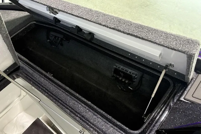 Slide: The Image of Open storage compartment in 2026 Phoenix 920 Elite X boat. - 14